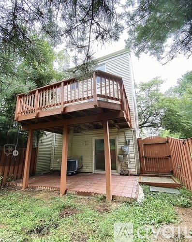 A wooden deck is attached to a house.