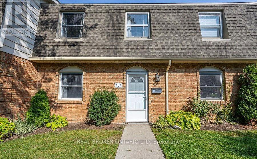 A house with a white door and windows is for sale.