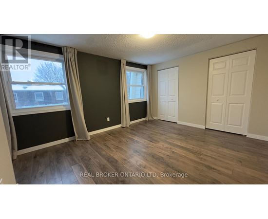 A room with a window and a door is shown in this image.