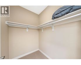 A bedroom with a bed on top of a shelf.