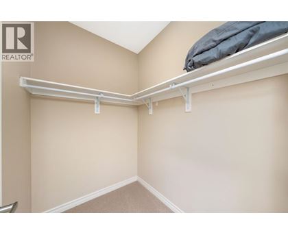 A bedroom with a bed on top of a shelf.