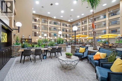A spacious outdoor seating area with multiple tables and chairs.