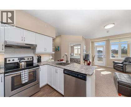 A modern kitchen with a stove top oven and a dishwasher.