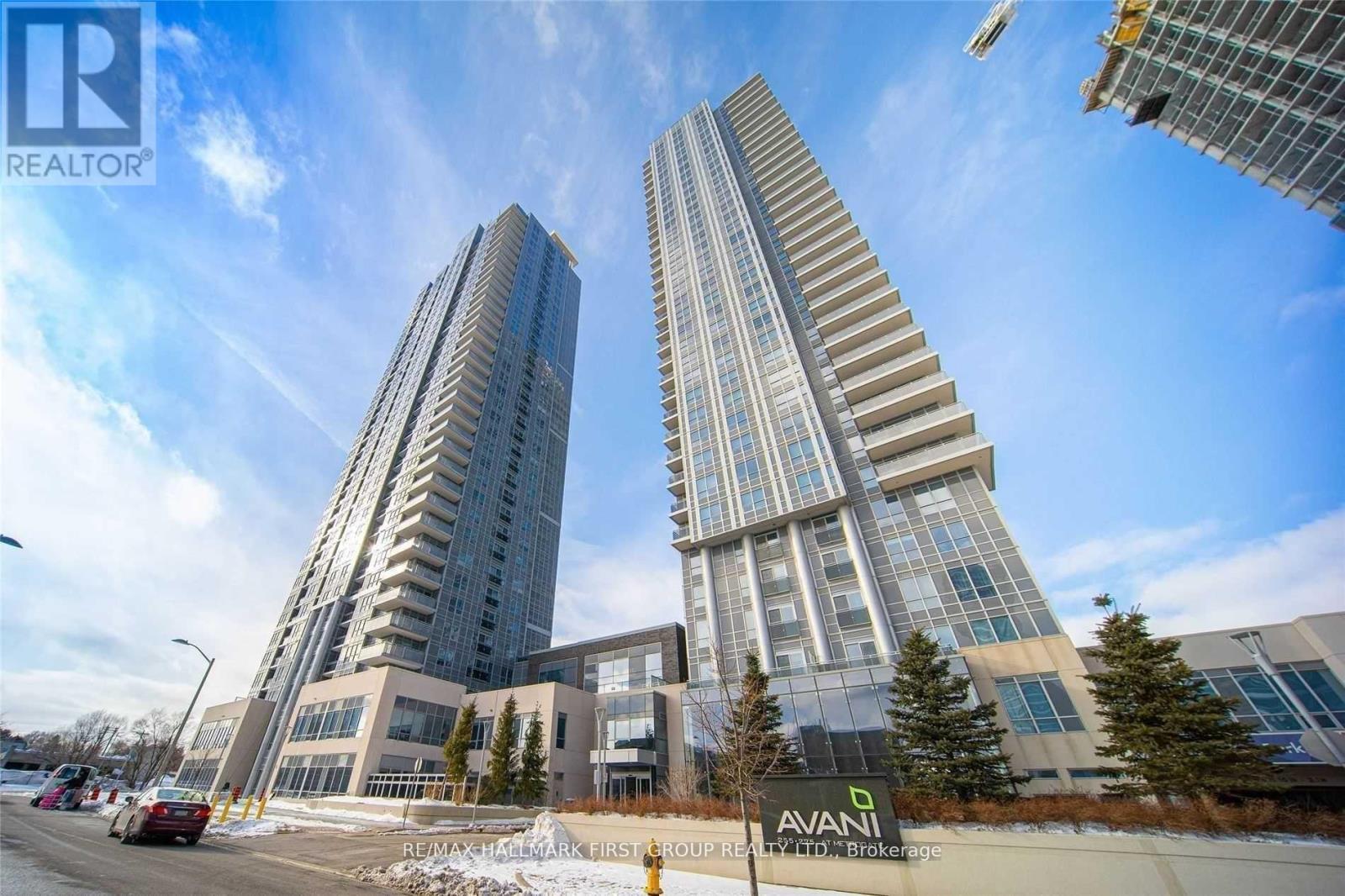 Two tall buildings with the sign "AVANI" in front of them.