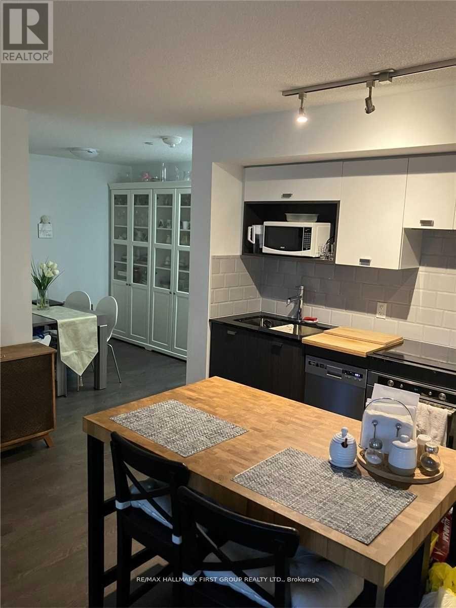 A kitchen with a wooden table and chairs.
