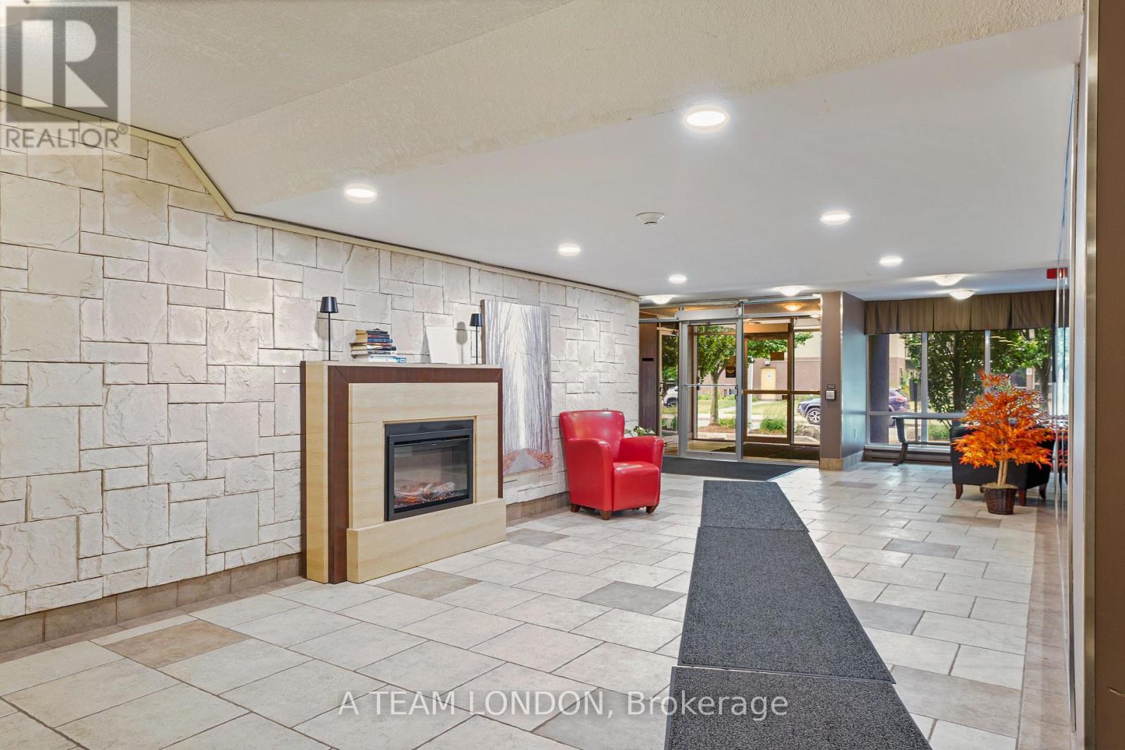 A brokerage office with a stone wall and a fireplace.