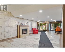 A brokerage office with a stone wall and a fireplace.