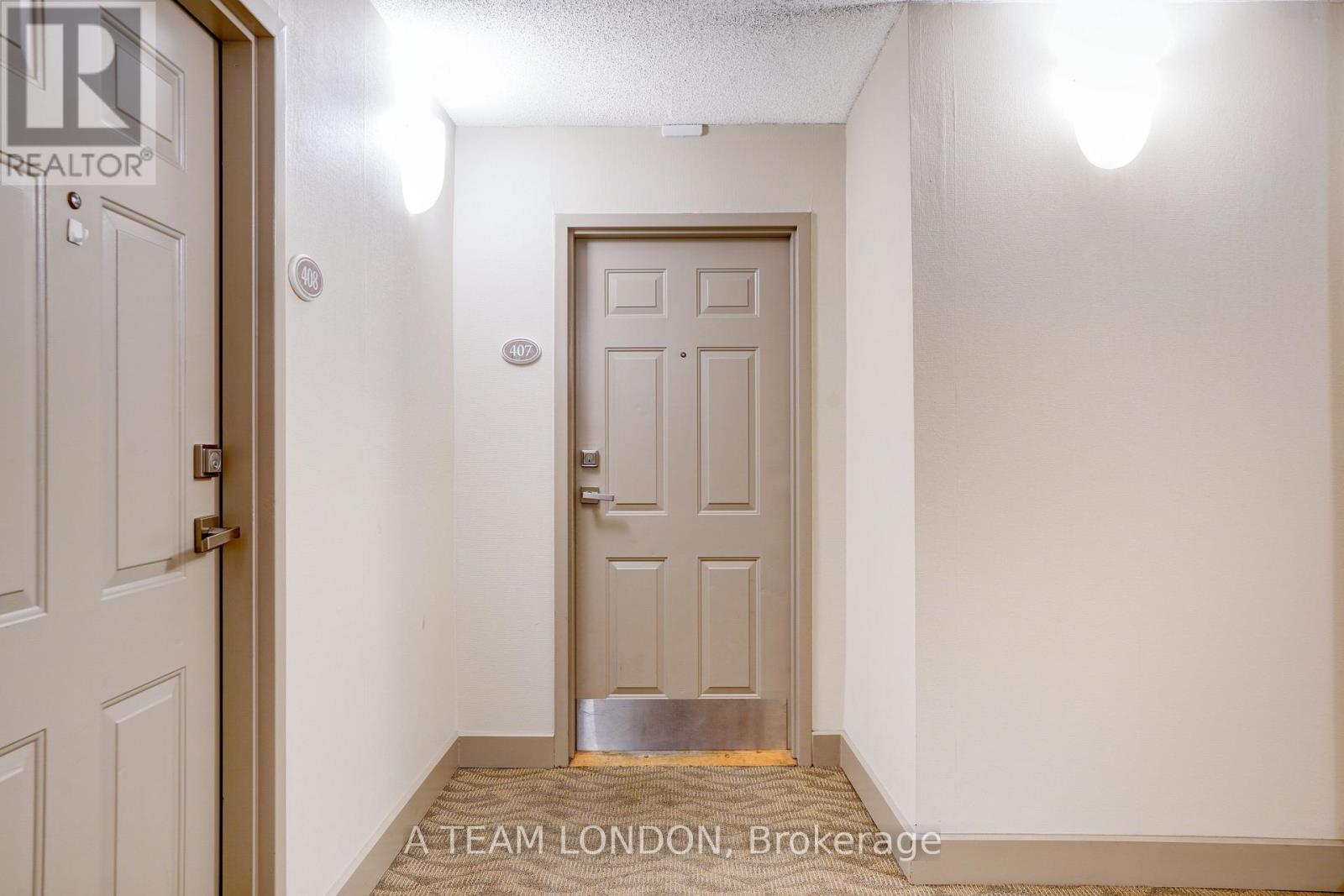 A white door with a silver handle is in a room with white walls.