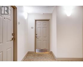 A white door with a silver handle is in a room with white walls.