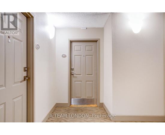 A white door with a silver handle is in a room with white walls.