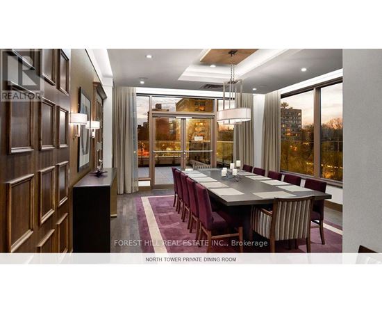 A dining room with a long table and chairs.