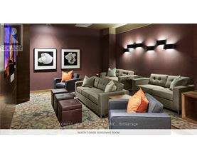 A living room with a couch, chair, and ottoman.