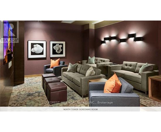 A living room with a couch, chair, and ottoman.
