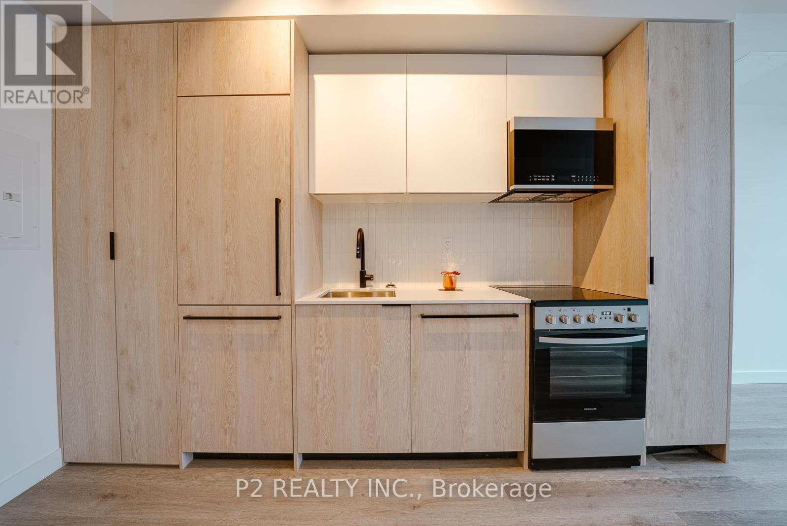 A modern kitchen with wooden cabinets and a stainless steel oven.