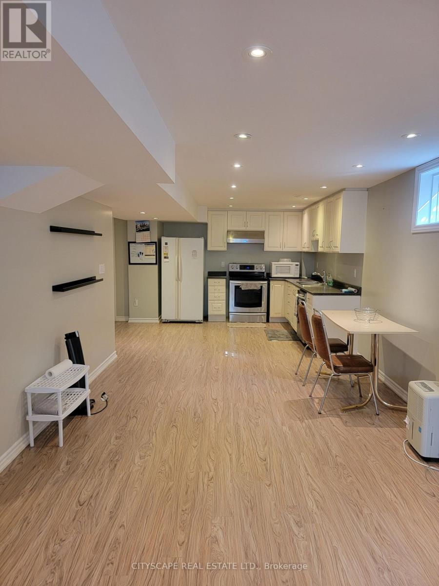 A real estate listing image of a kitchen and dining area.