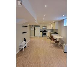 A real estate listing image of a kitchen and dining area.