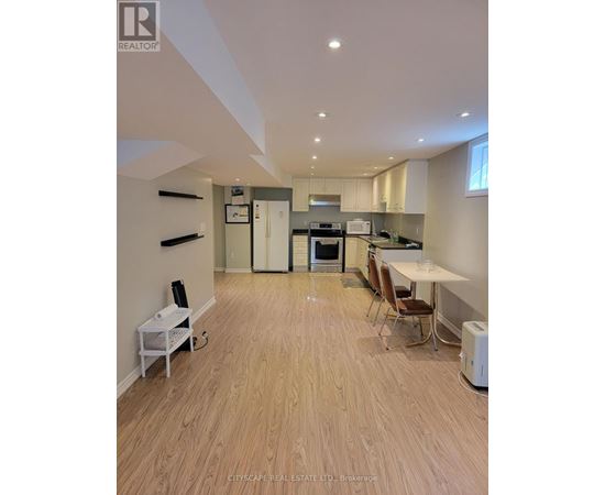 A real estate listing image of a kitchen and dining area.