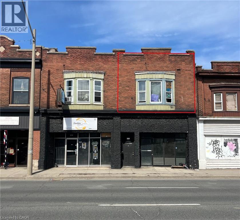 A building with a REALTOR sign on the left side.
