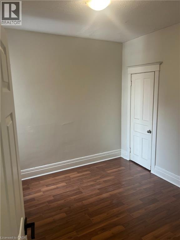 A room with a wooden floor and a white door.