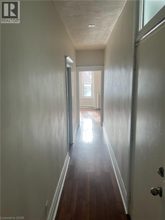 A long hallway with a door at the end.