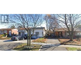 A street view of a residential area with houses and parked cars.