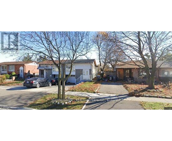 A street view of a residential area with houses and parked cars.