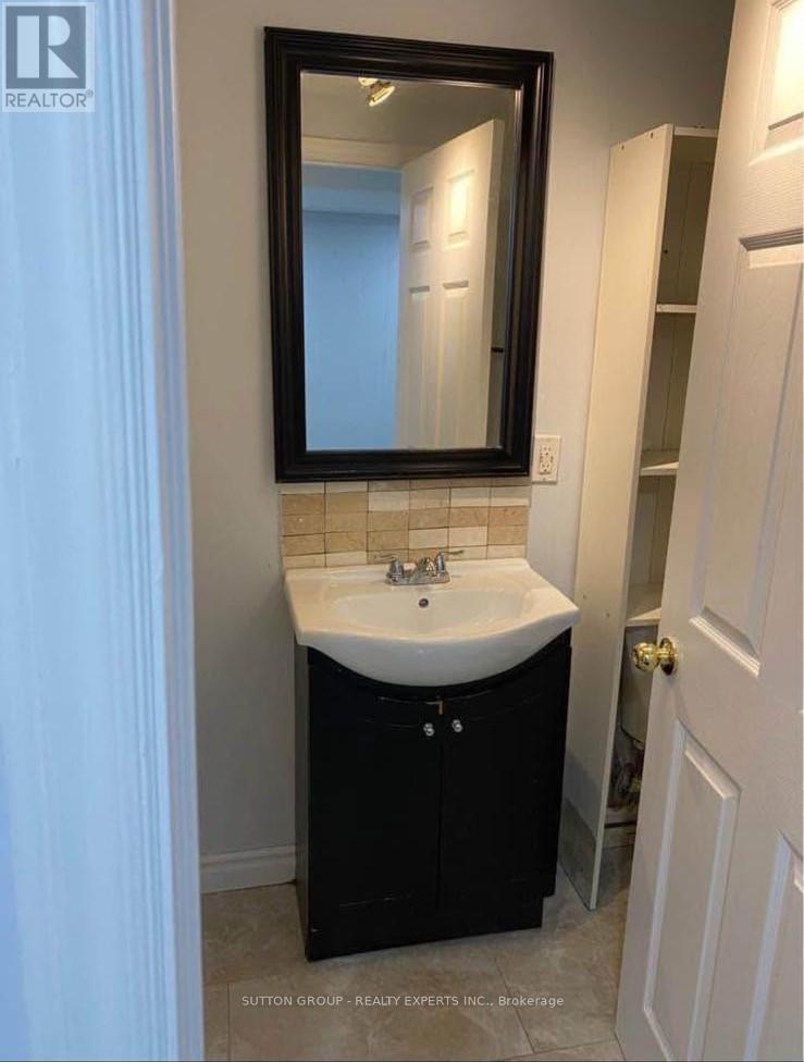 A bathroom with a sink and mirror.