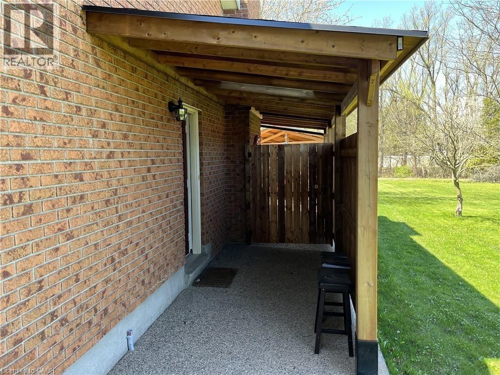 A covered outdoor patio area with a black stool.