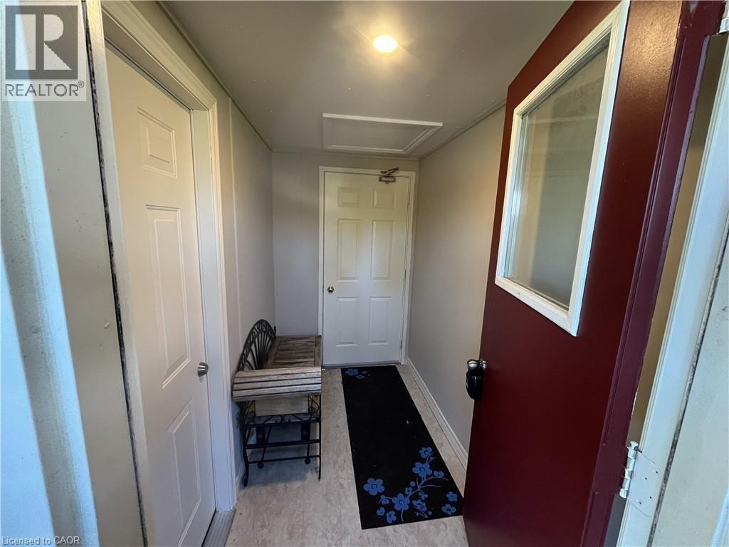 A hallway with a bench and a door.
