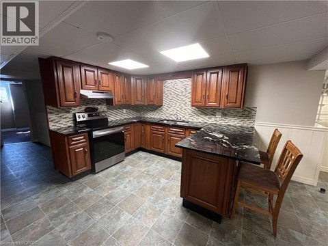A kitchen with wooden cabinets and a granite countertop.