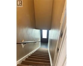 A house with a white staircase leading to the second floor.