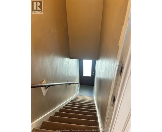 A house with a white staircase leading to the second floor.