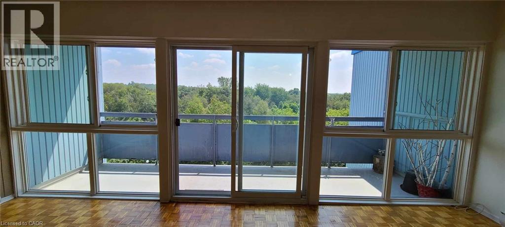 A balcony with a view of a forest and a fence.