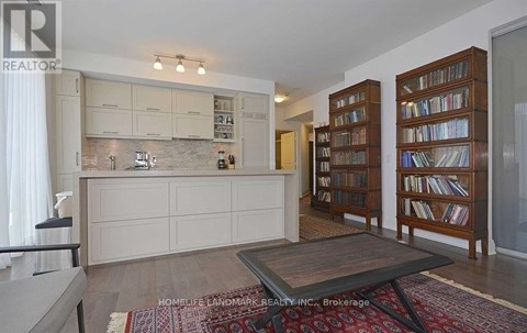 A living room with a rug and a coffee table.