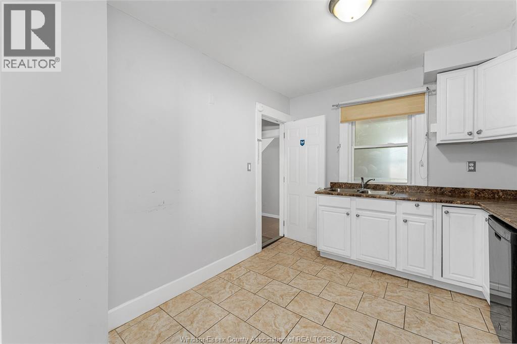A kitchen area with a sink and cabinets.