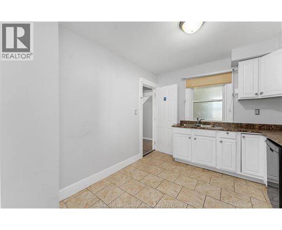 A kitchen area with a sink and cabinets.