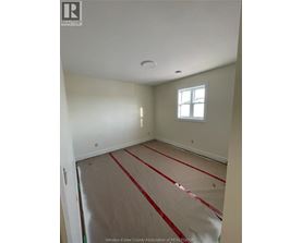 A room with a window and a floor covered in red tape.