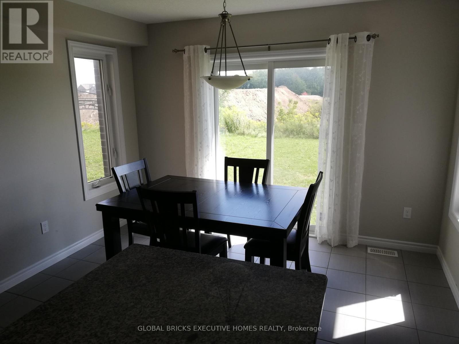 A dining room with a table and chairs.