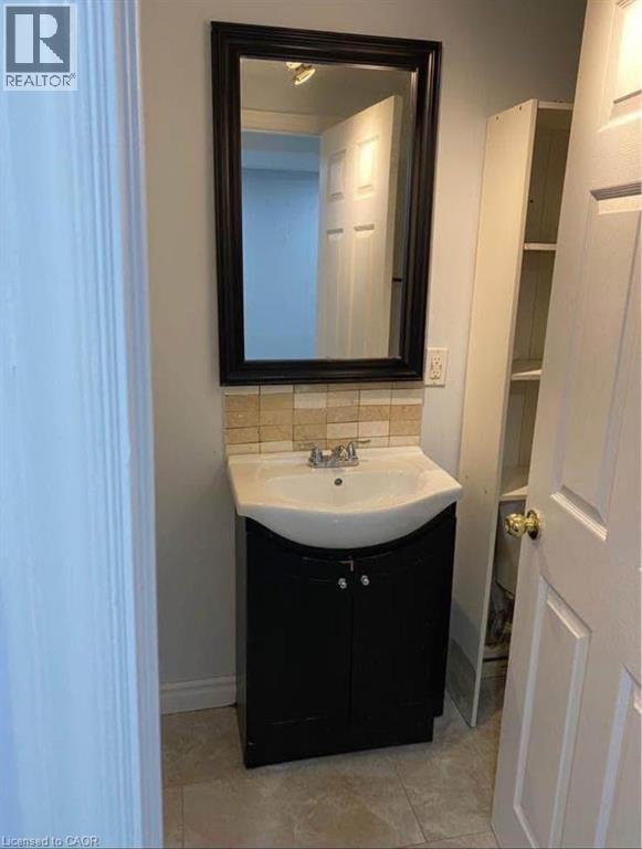 A bathroom with a sink and mirror.