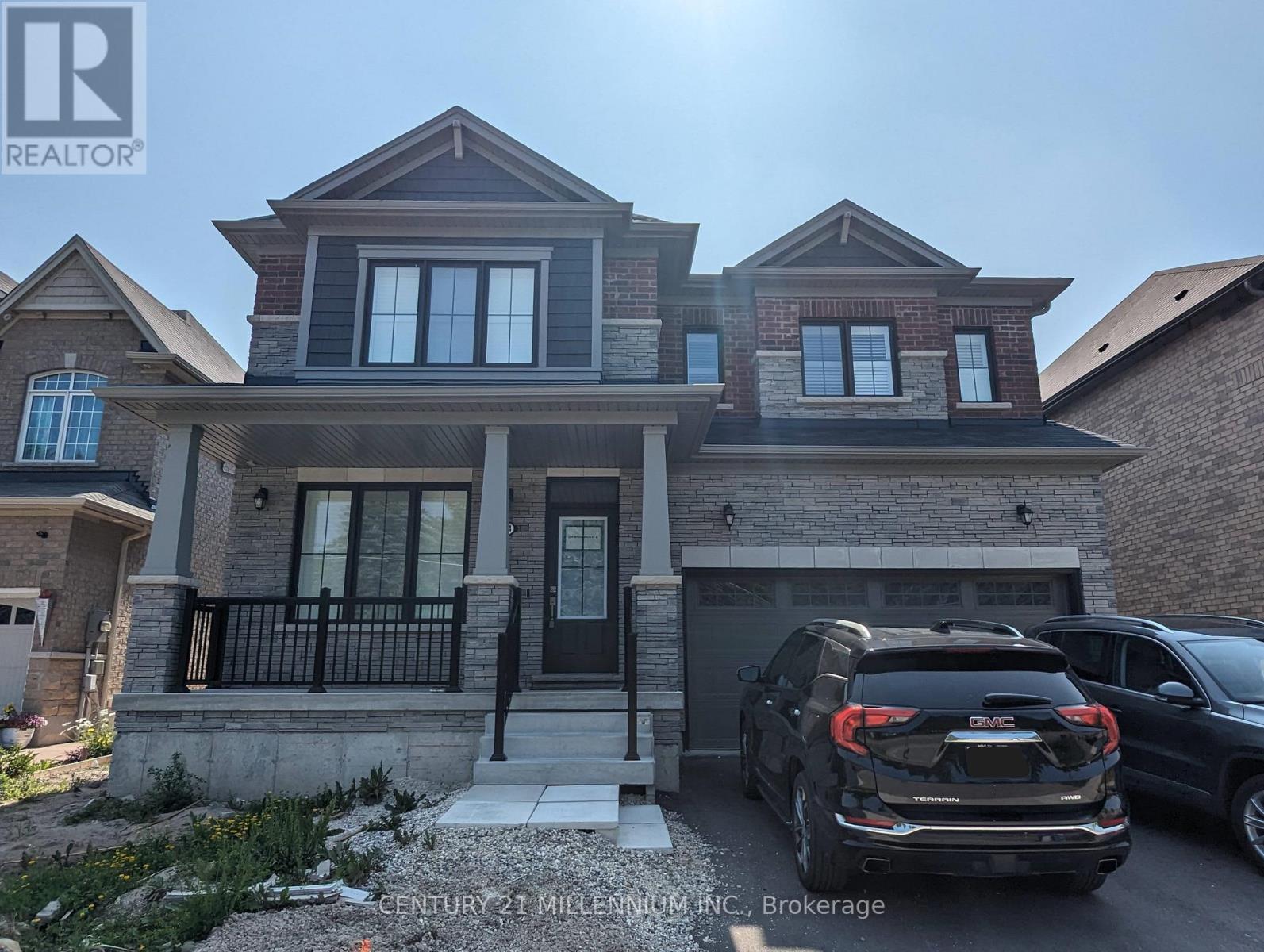 A house with a car parked in front of it.