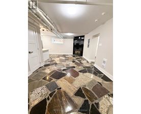 A tile floor with a mix of brown and black tiles.