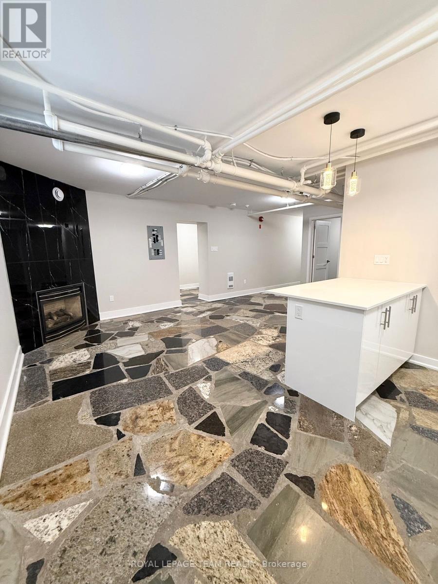 A kitchen with a stone floor and a white cabinet.