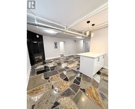 A kitchen with a stone floor and a white cabinet.