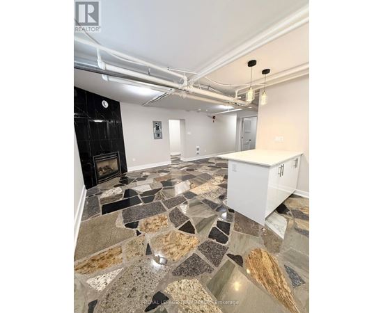 A kitchen with a stone floor and a white cabinet.