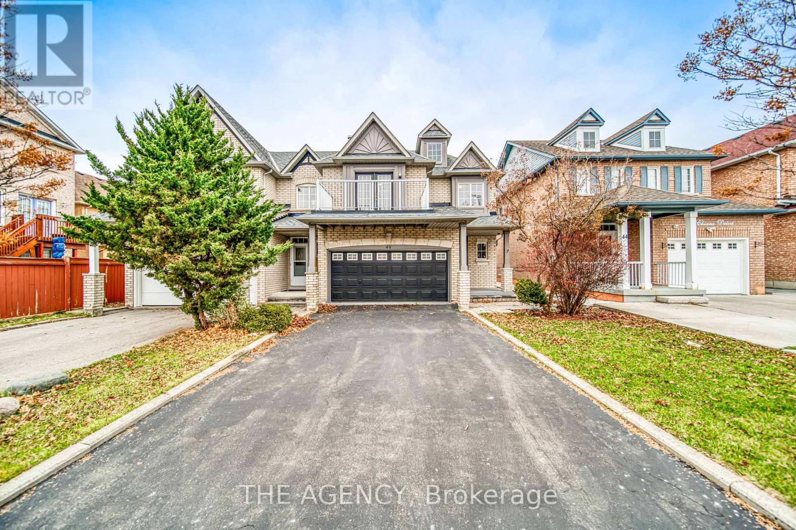 A large house with a driveway in front of it.