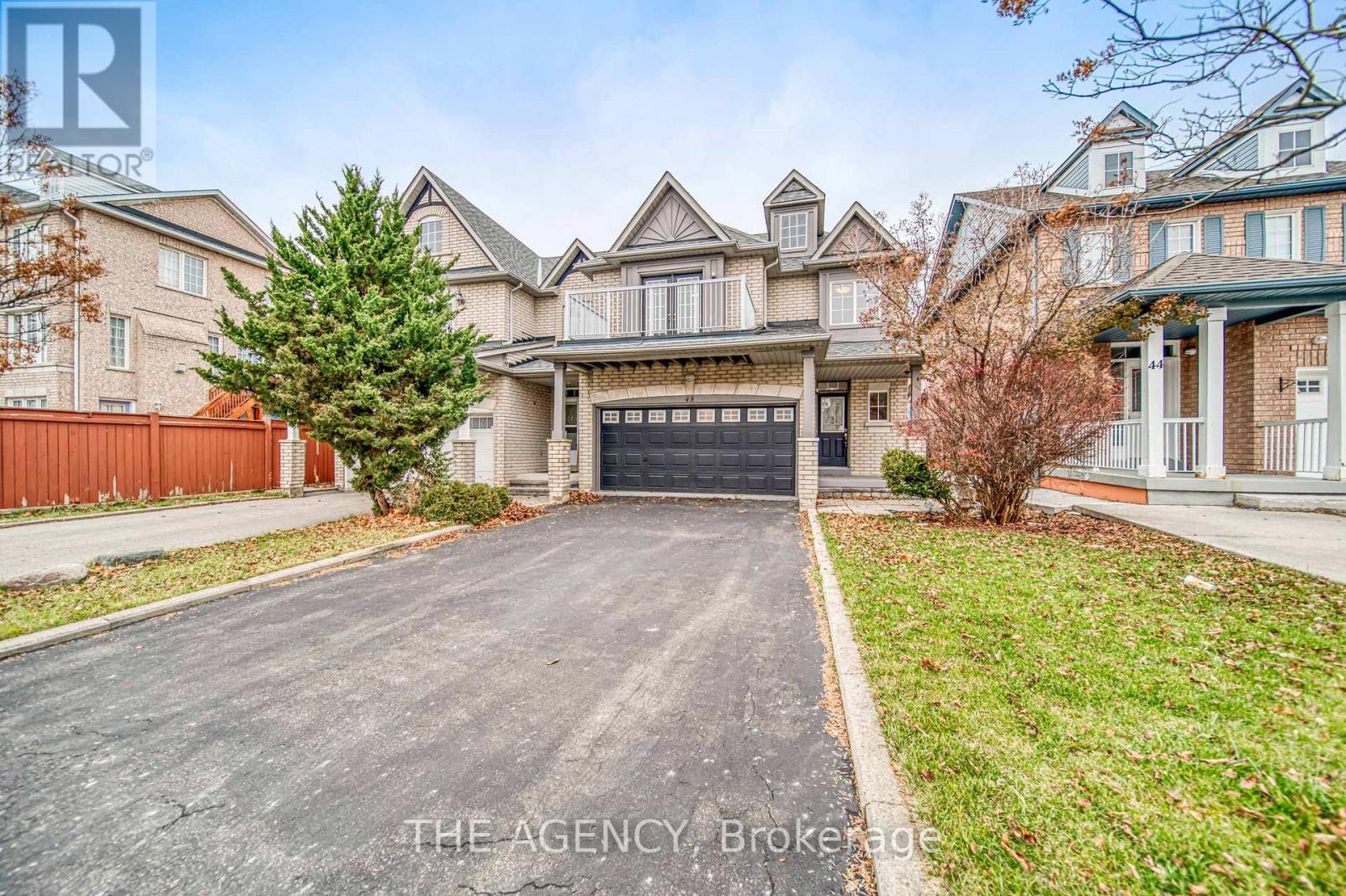 A large house with a driveway in front of it.