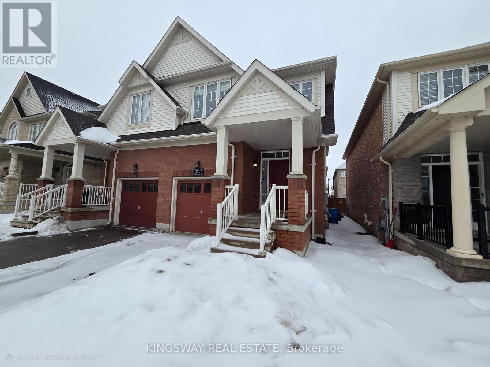 A row of houses with snow on the ground in front.