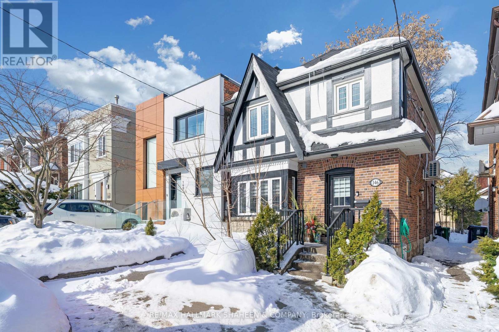 A house with a snow-covered front yard.