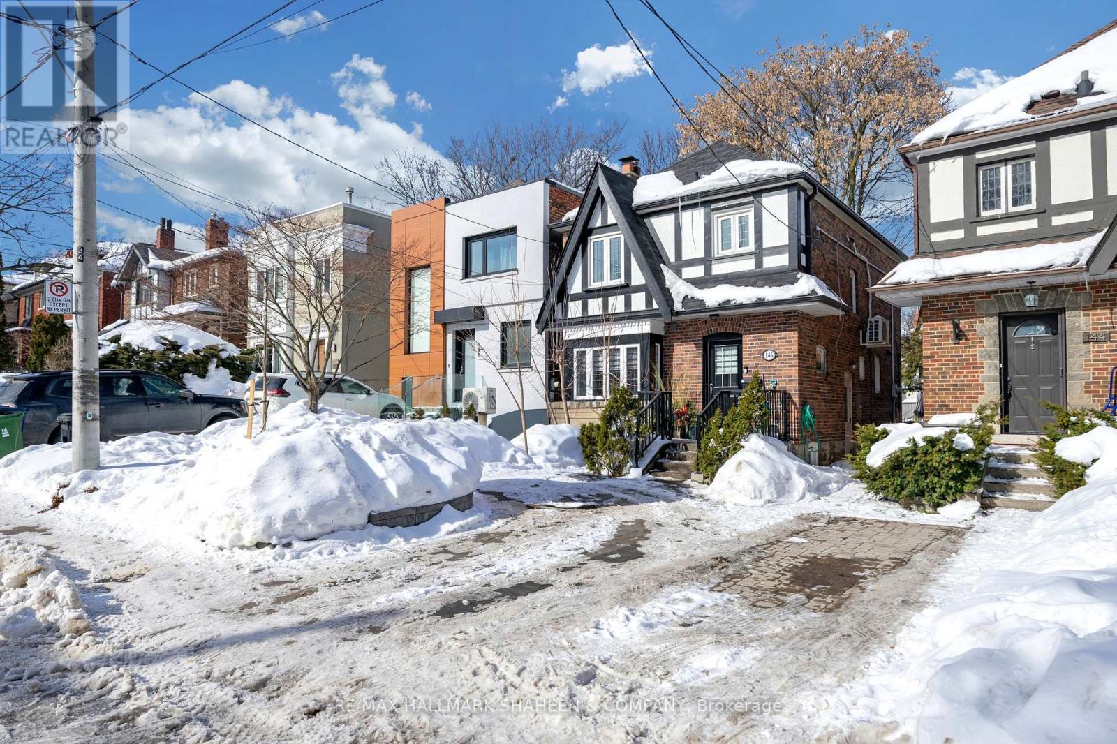 A snow-covered street with houses on either side.