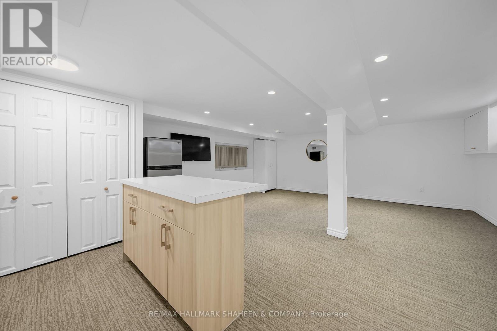A spacious room with a wooden cabinet and a television on the counter.